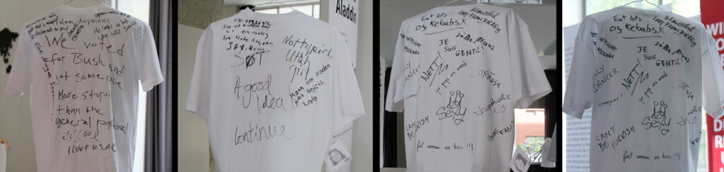 White t-shirts that have been written on with marker.